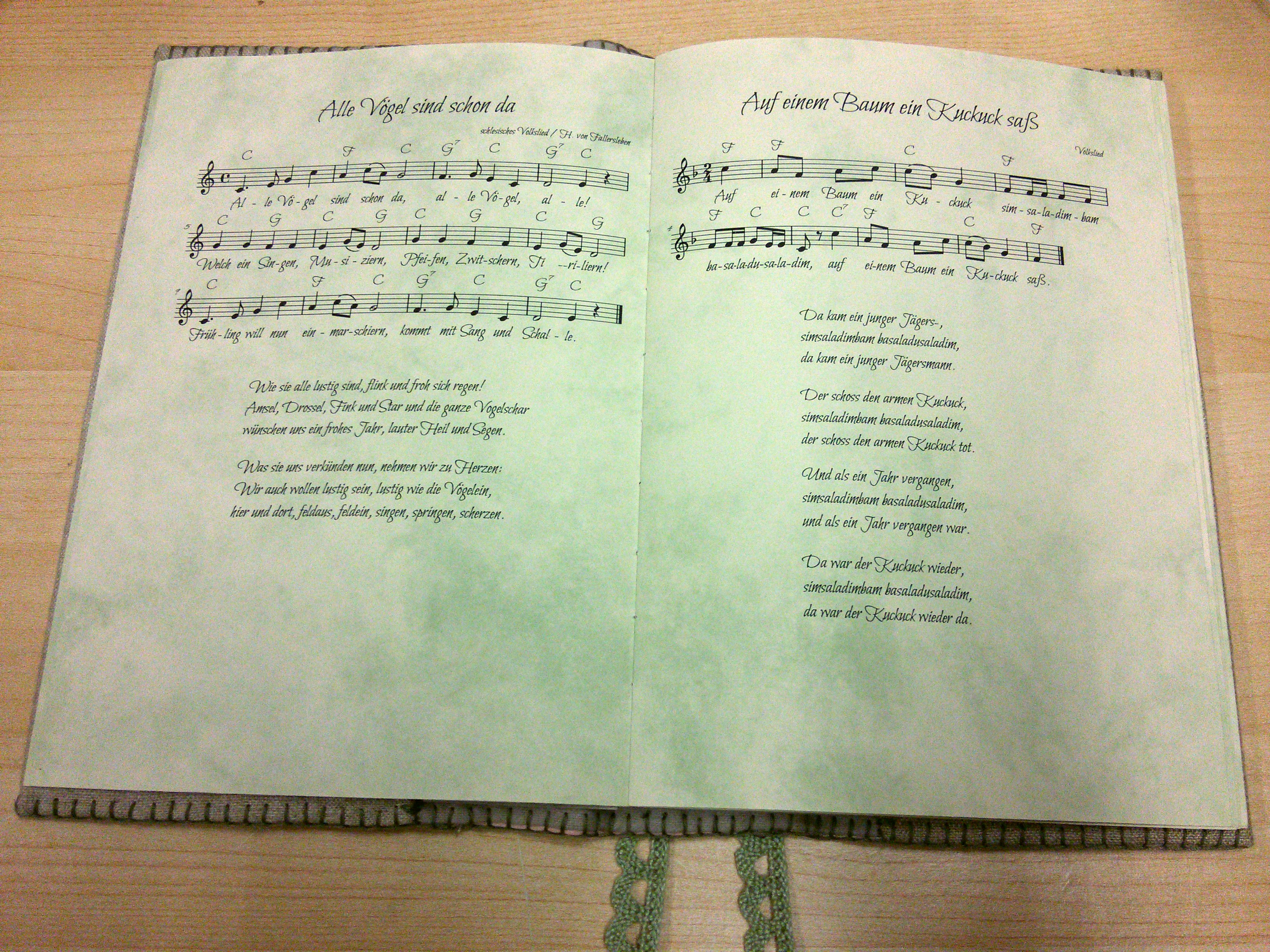 A photo of my songbook, open to show some pages with songs on them.